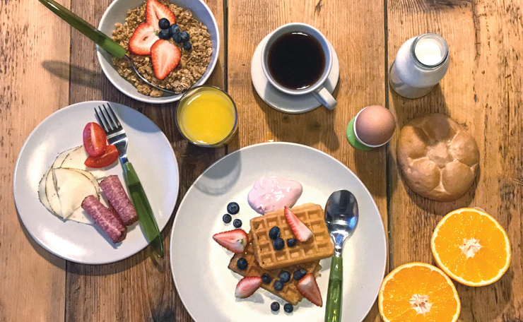 Breakfast with fresh fruit, waffles and coffee