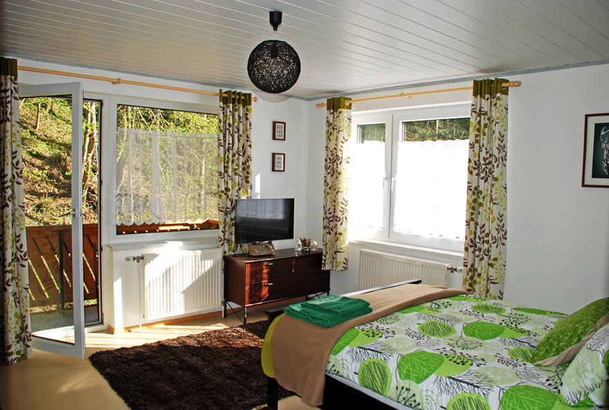 A bright, comfortable guest room opening onto the garden